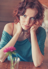 Obraz premium Vintage toned Redhead sitting in the cafee