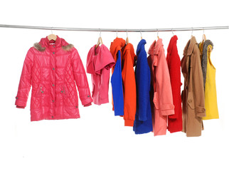 Set of colorful coat clothes hanging on clothes rack