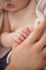 Father with baby. Little baby holding fathers finger and sleepin