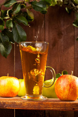 A glass of apple juice with fresh fruits