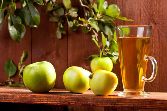 A glass of apple juice with fresh fruits