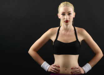 Obraz premium Portrait of a sexy fitness woman isolated on black