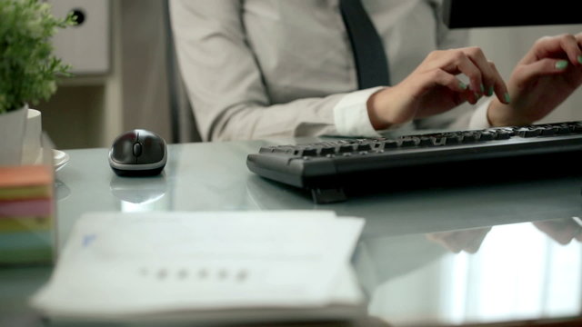Businesswoman typing on keyboard in the office