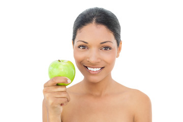 Cheerful black haired model holding green apple