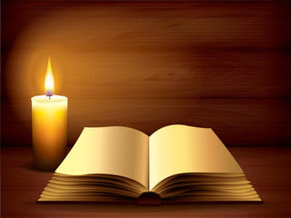 Opened ancient book and candle on dark
