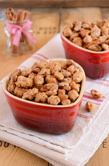 Caramelized almond with cinnamon in heart-shaped red bowls