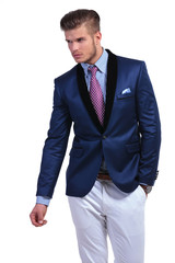 young business man looks away with hand in pocket