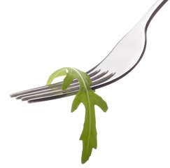 Fresh rucola  salad on fork isolated on white background cutout.
