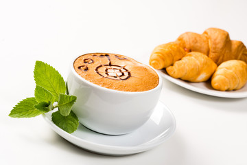 large cup of coffee and croissants on a plate