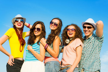 group of young people wearing sunglasses and hat