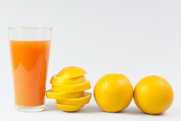 Orange juice and slices of orange on white