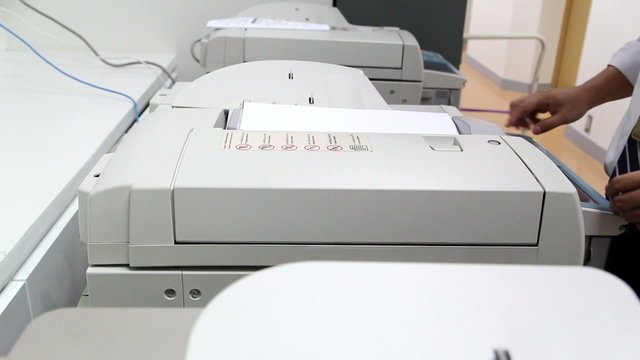 office man using paper copy machine