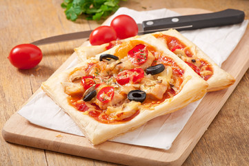 slices of pizza with chicken and tomatoes