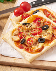 slices of pizza with chicken and tomatoes