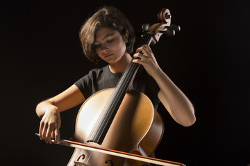 Young woman plays cello © mikhaluk