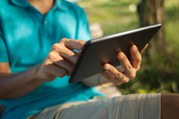 Man using a digital tablet outdoors - 56164924