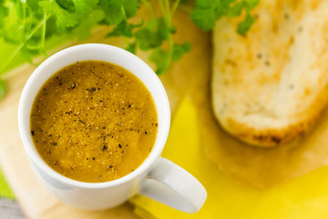 Cup of soup with pepper and naan