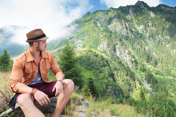 casual man looks back at mountain