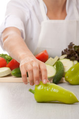Woman chef and green pepper