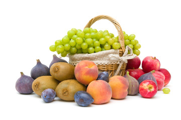 basket with grapes and other fruit on a white background