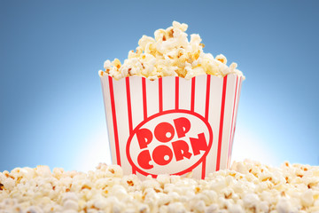 Popcorn in box overflowing with freshly popped corn