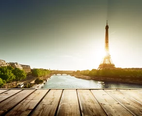 Foto auf Acrylglas background with wooden deck table and  Eiffel tower in Paris © Iakov Kalinin