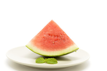 slice of watermelon with a triangle shaped on plate