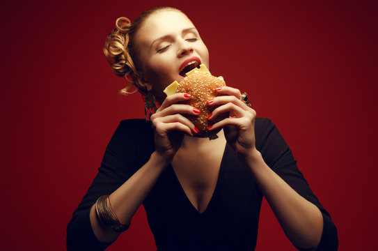 Junk Food Concept. Guilty Pleasure. Girl Eating Burger