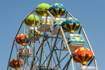 Ferris wheel with carriages in different colors.