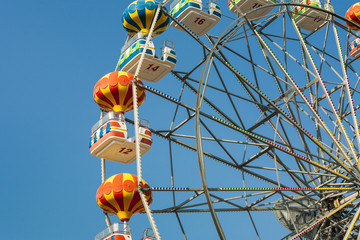 Ferris wheel with carriages in different colors.