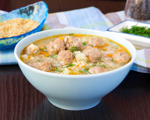 Delicious and healthy hot soup with barley bulgur and small meat