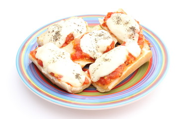 Casserole with mozzarella, tomato and basil on colored plate