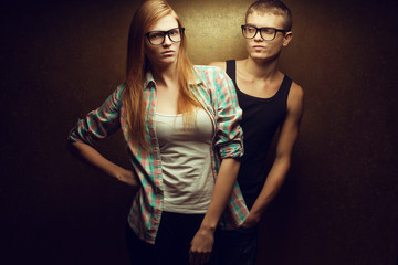 Portrait of gorgeous red-haired fashion twins in trendy glasses