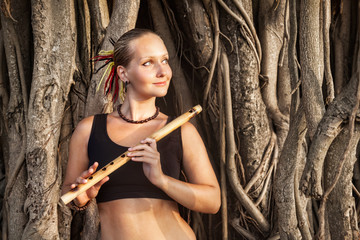 Woman with bamboo flute © pikoso.kz