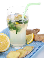 Glass of cold tea with ginger on napkin isolated on white