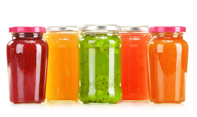 Jars of fruity jams isolated on white background