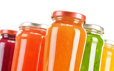 Jars of fruity jams isolated on white background