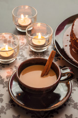 Fresh coffee and cinnamon with candlelight.