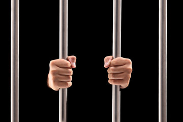 Male hands holding prison bars - obrazy, fototapety, plakaty