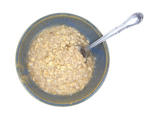 Oatmeal cereal in bowl with spoon