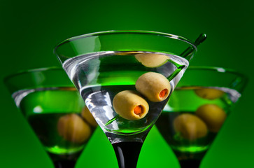 glasses with martini and green olives