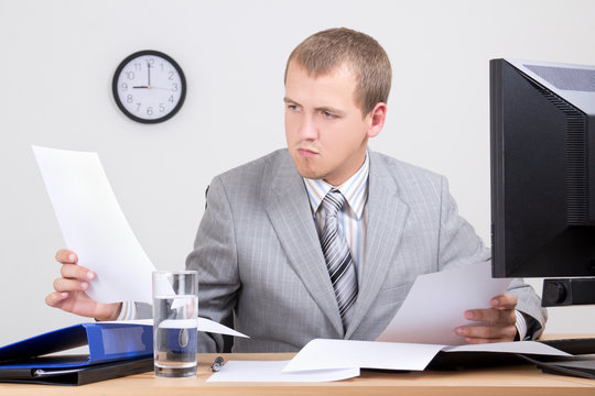 Worried Accountant Doing Paperwork In Office