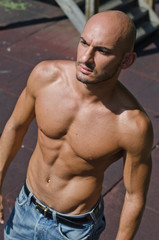Fototapeta na wymiar Handsome bald young man shirtless outdoors