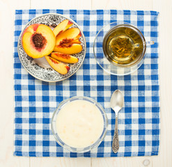 Breakfast. Green tea, youghurt and peach