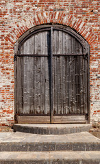 Old weathered wooden gate of ancient church