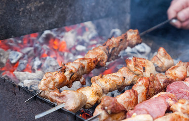 Juicy slices of meat with sauce prepare on coals