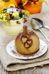 Baked apple decorated with cinnamon heart shape ornament