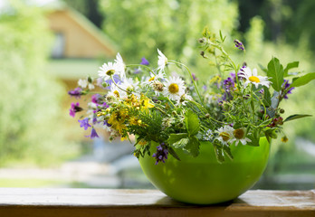 beautiful bouquet of bright wildflowers on a wooden background