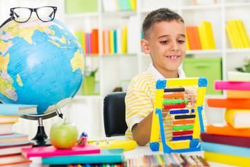 little  boy studying with abacus