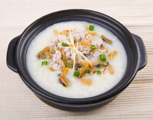 Traditional chinese pork porridge rice gruel served in claypot